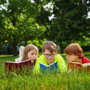 Kids reading in park