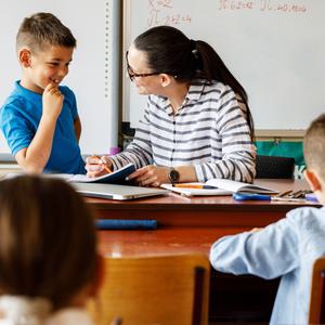 Teacher helping student