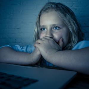 girl on computer in dark